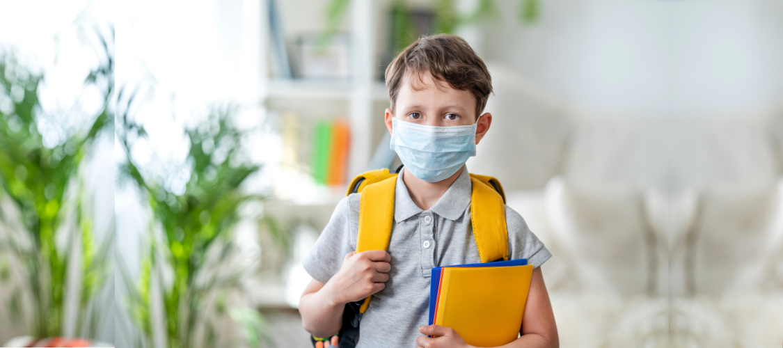 Young Boy with Mask Ready for Returning to School after Covid